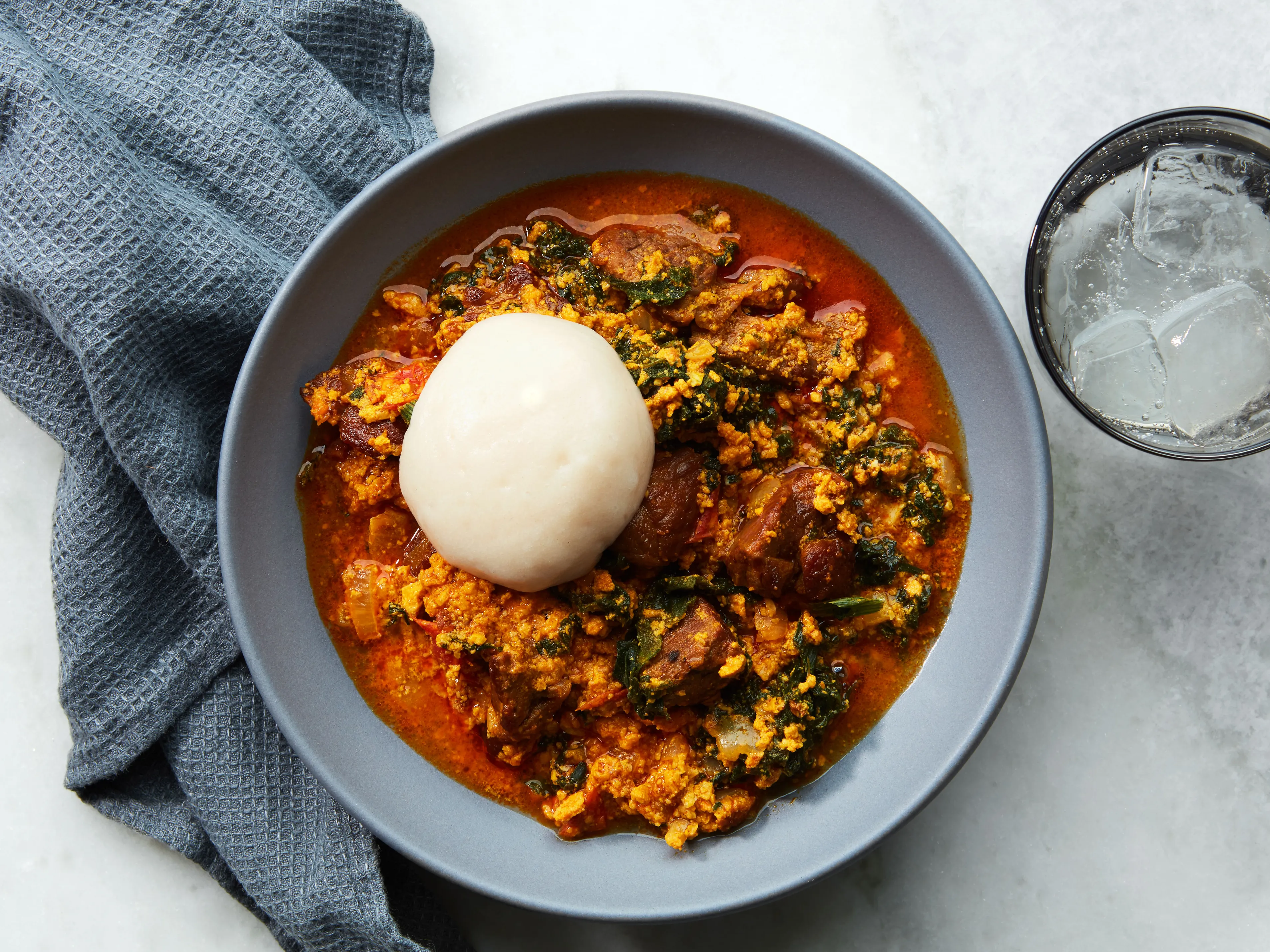 Egusi soup with some meat with pounded yam